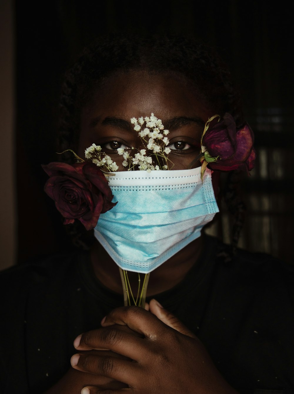 a woman wearing a face mask with flowers on her nose