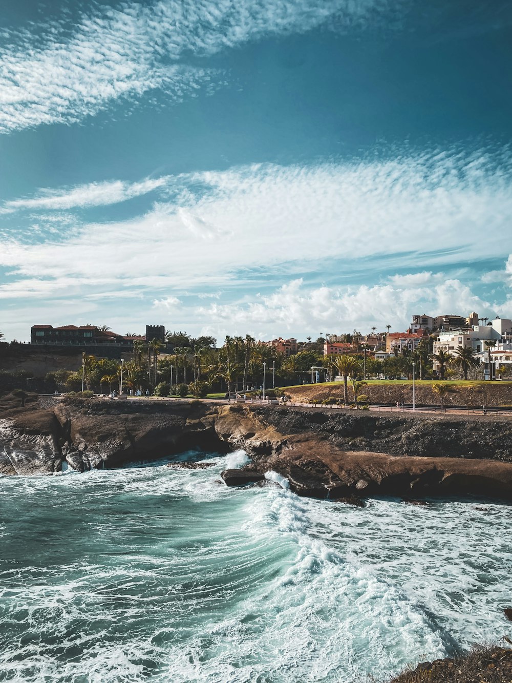 a view of a beach with waves crashing on the shore