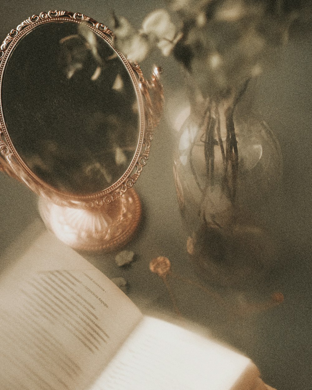 a mirror and a book on a table