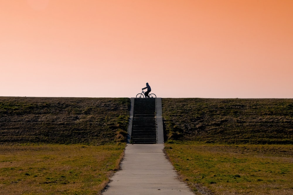 a person riding a bike down a flight of stairs