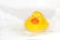 A bright yellow rubber duck with question marks floating around it.
