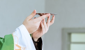 a person in a priest's robe holding a cell phone