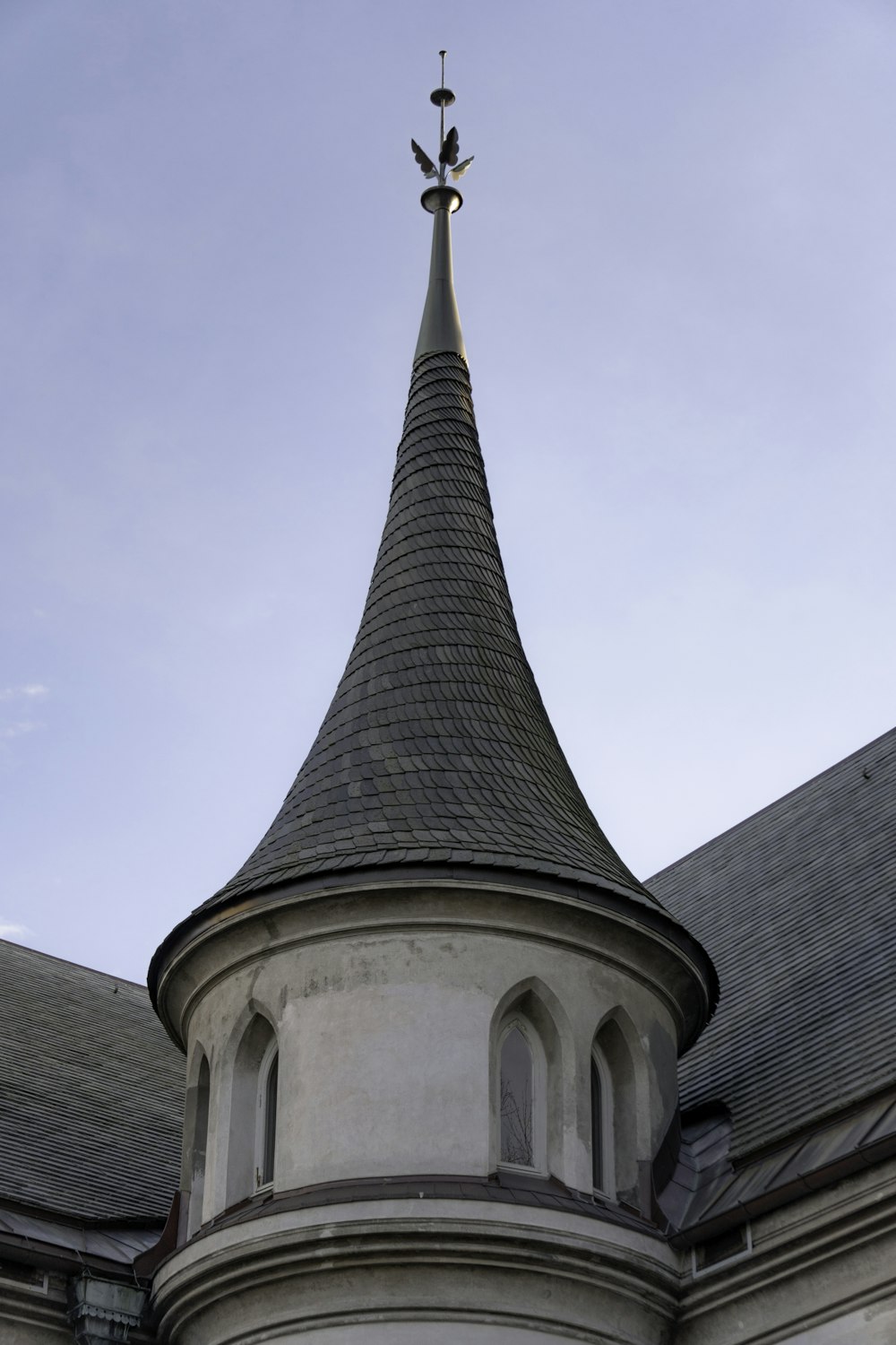 a white building with a steeple and a cross on top