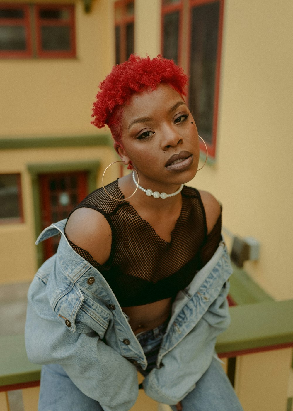 a woman with red hair sitting on a bench