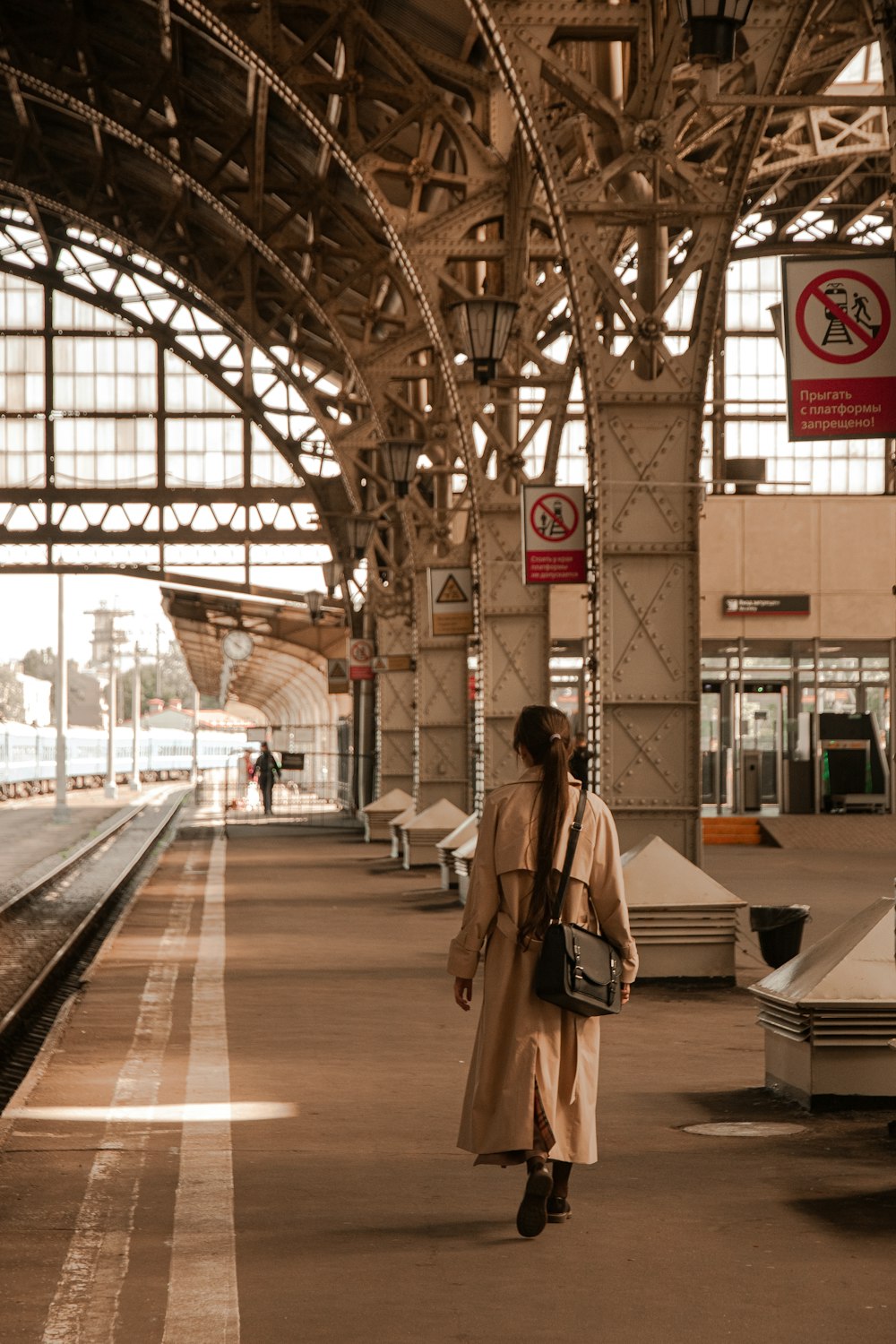 a woman walking down a train station platform