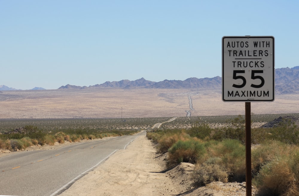 a speed limit sign on the side of a road