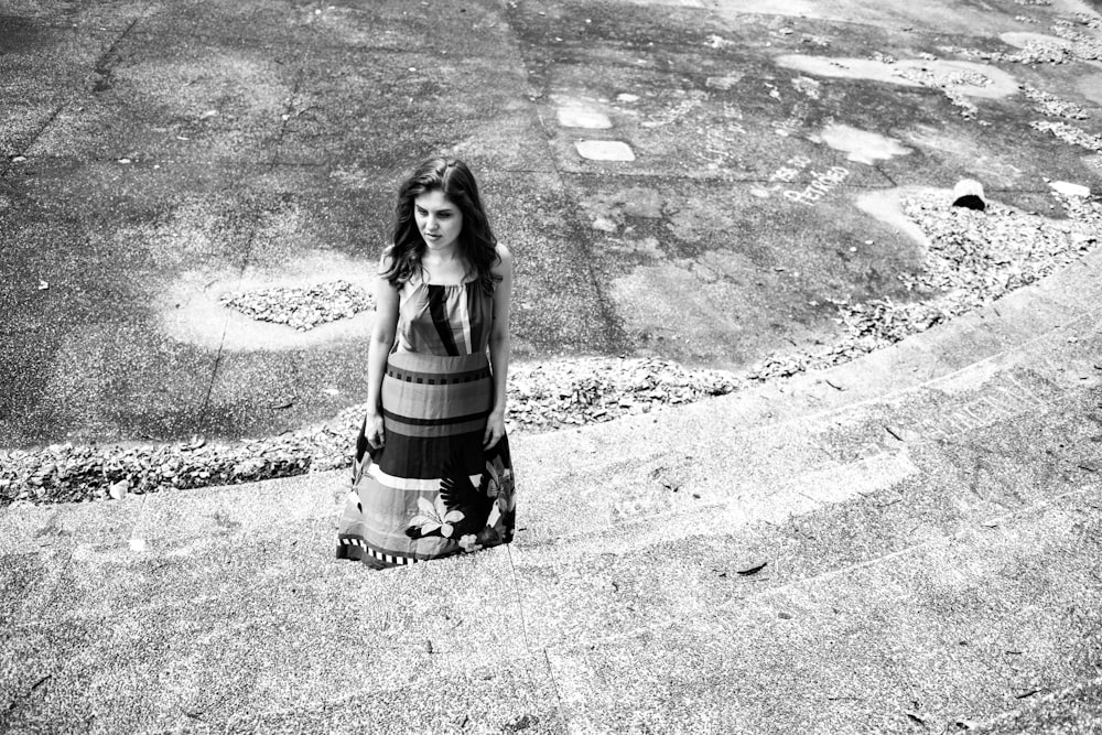 a woman sitting on the ground in a dress