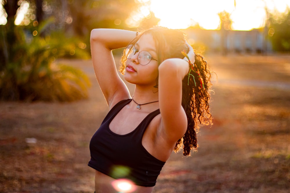 a woman in a black tank top is posing for a picture