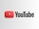 A prominent YouTube logo with a red play button icon on the left and the word 'YouTube' in bold black letters on the right, set against a light gray background.