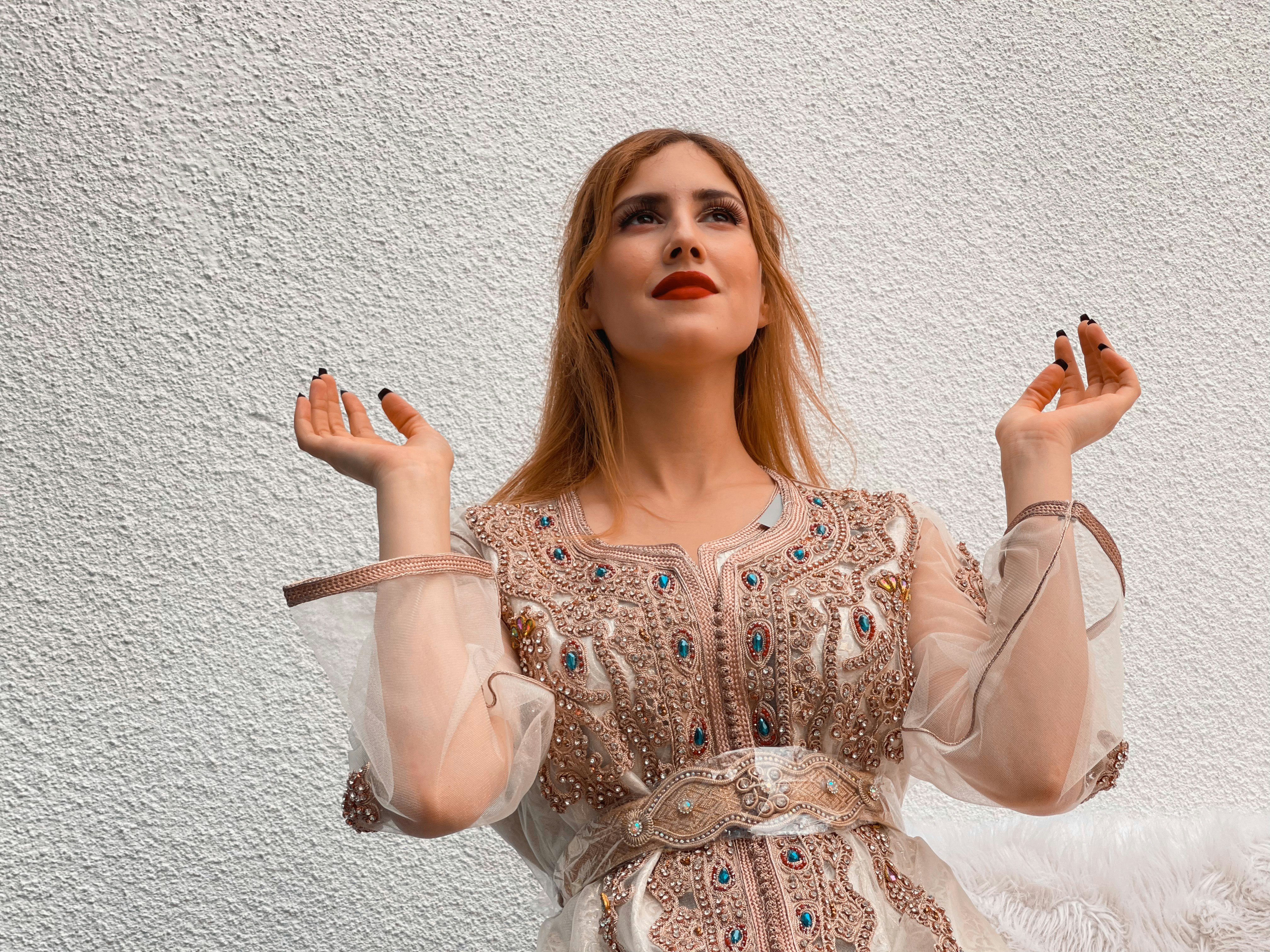 a woman in a dress holding a cigarette