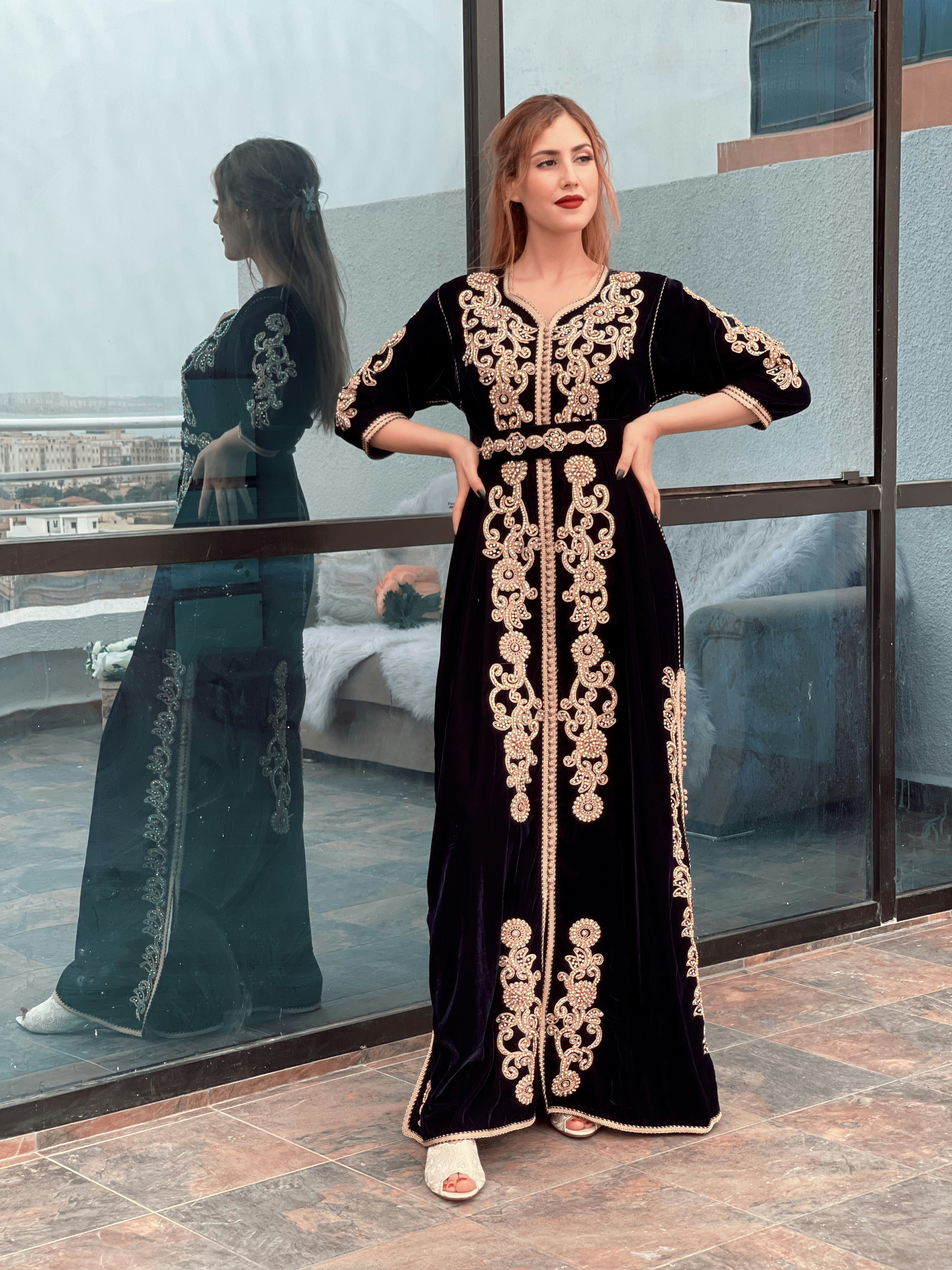 a woman standing in front of a window