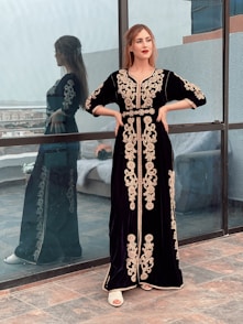 a woman standing in front of a window