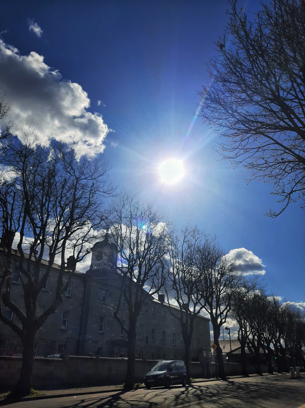 the sun shines brightly over a large building