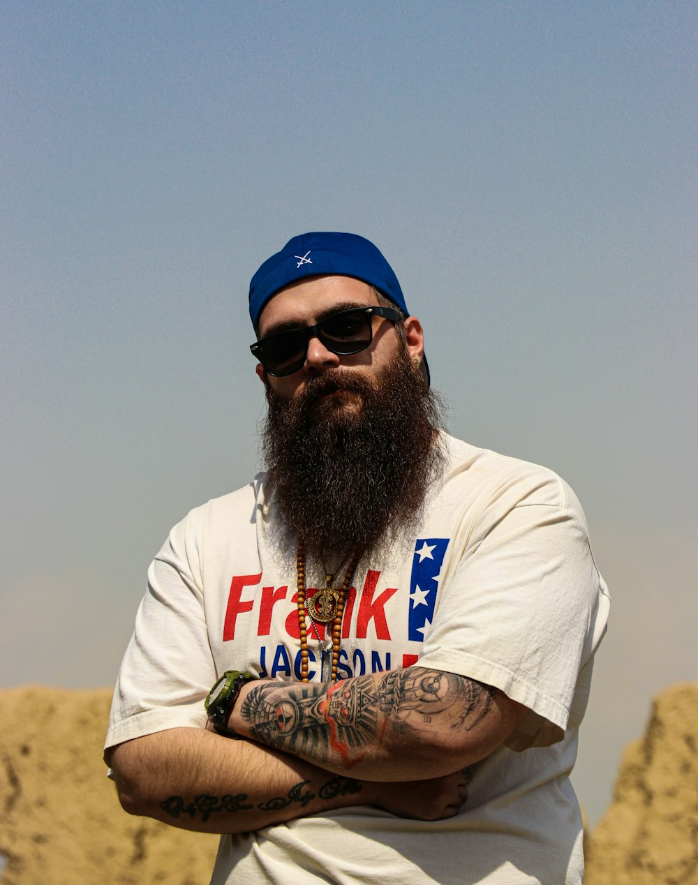 a man with a long beard wearing sunglasses and a hat