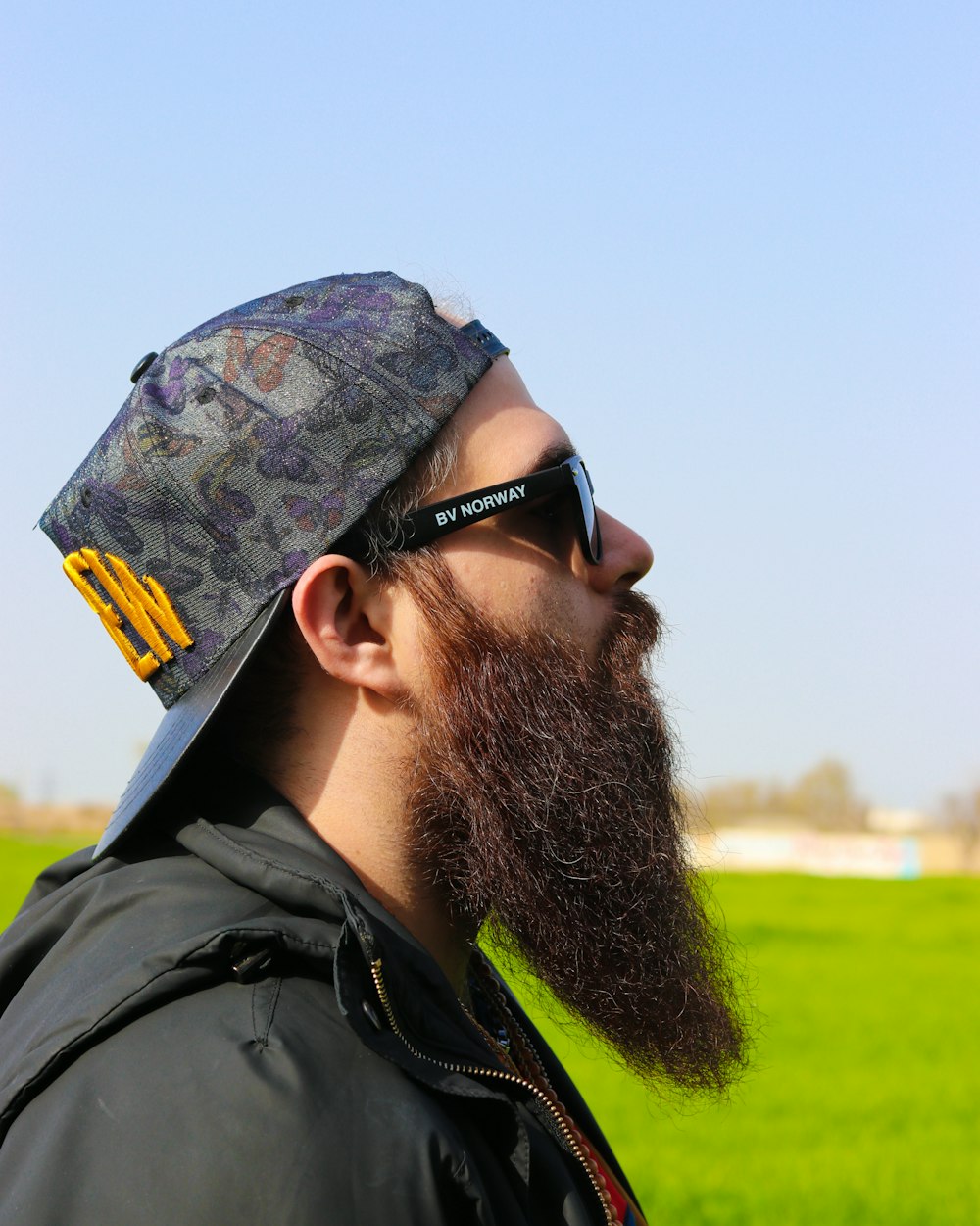 a man with a long beard wearing sunglasses and a hat