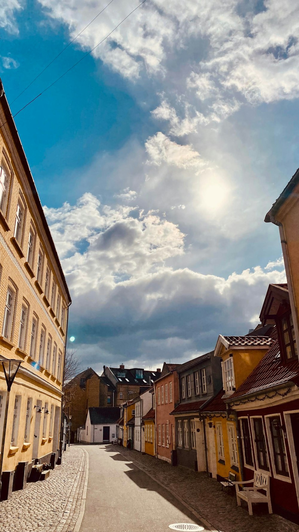 a street lined with buildings under a cloudy sky