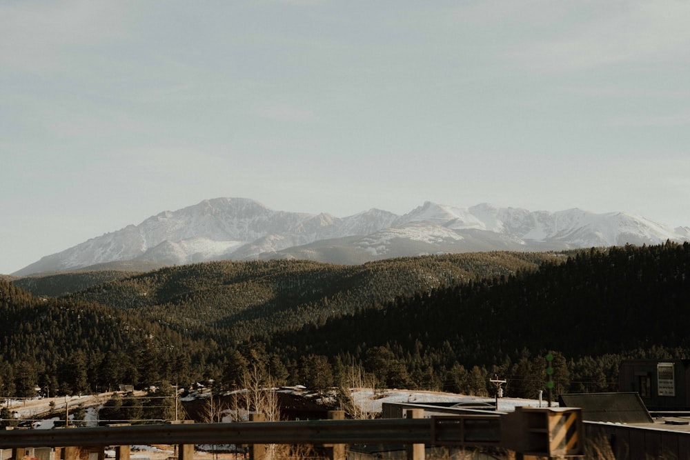 a view of a mountain range with a bridge in the foreground