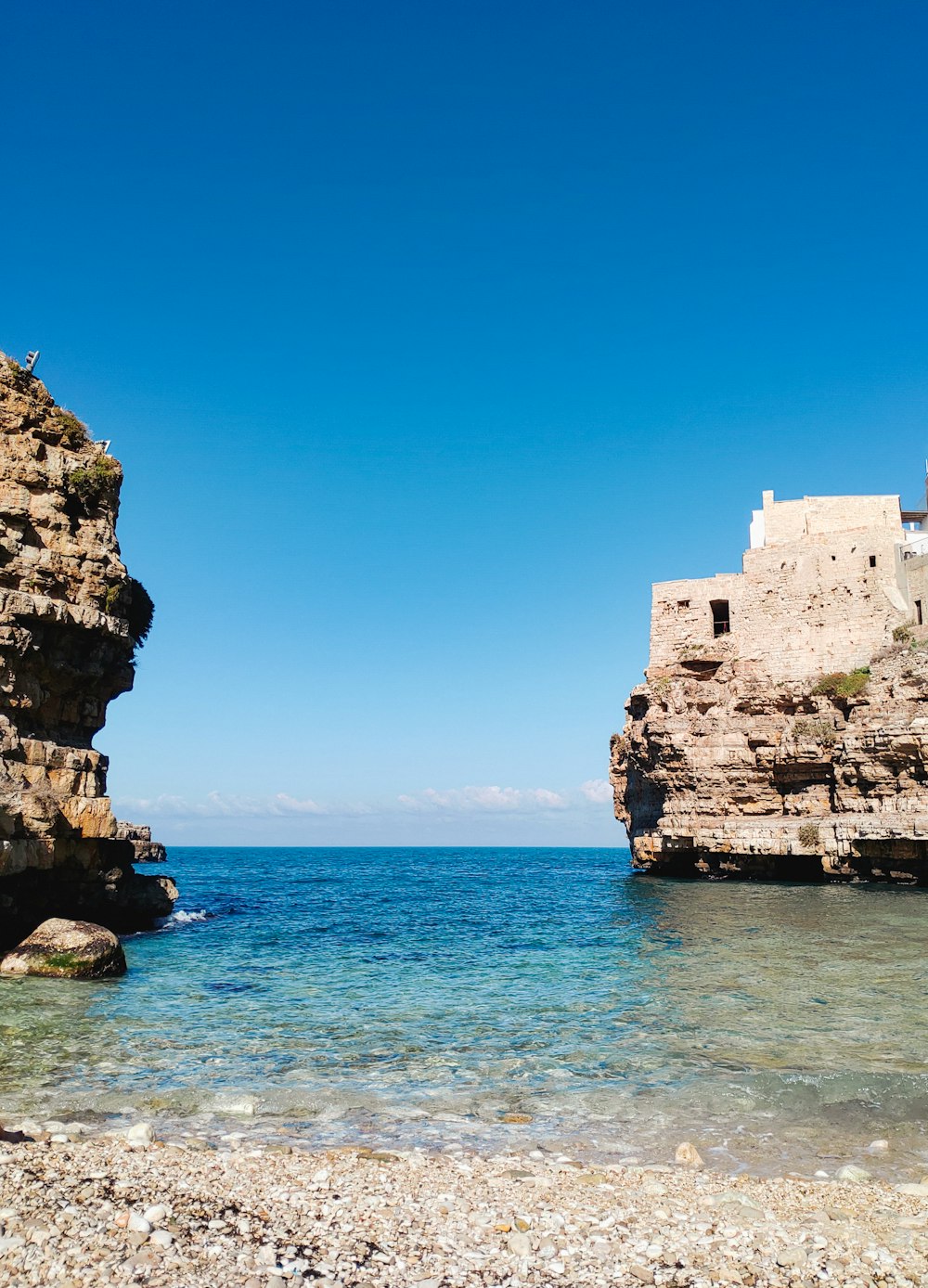 a view of a rocky beach with clear blue water