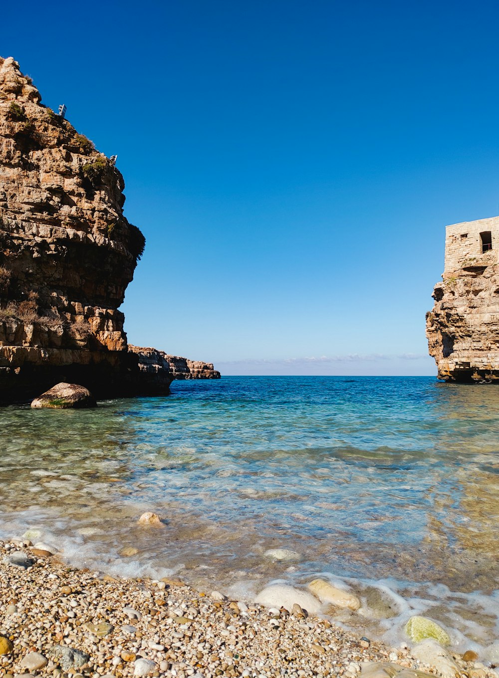 a rocky beach next to a body of water