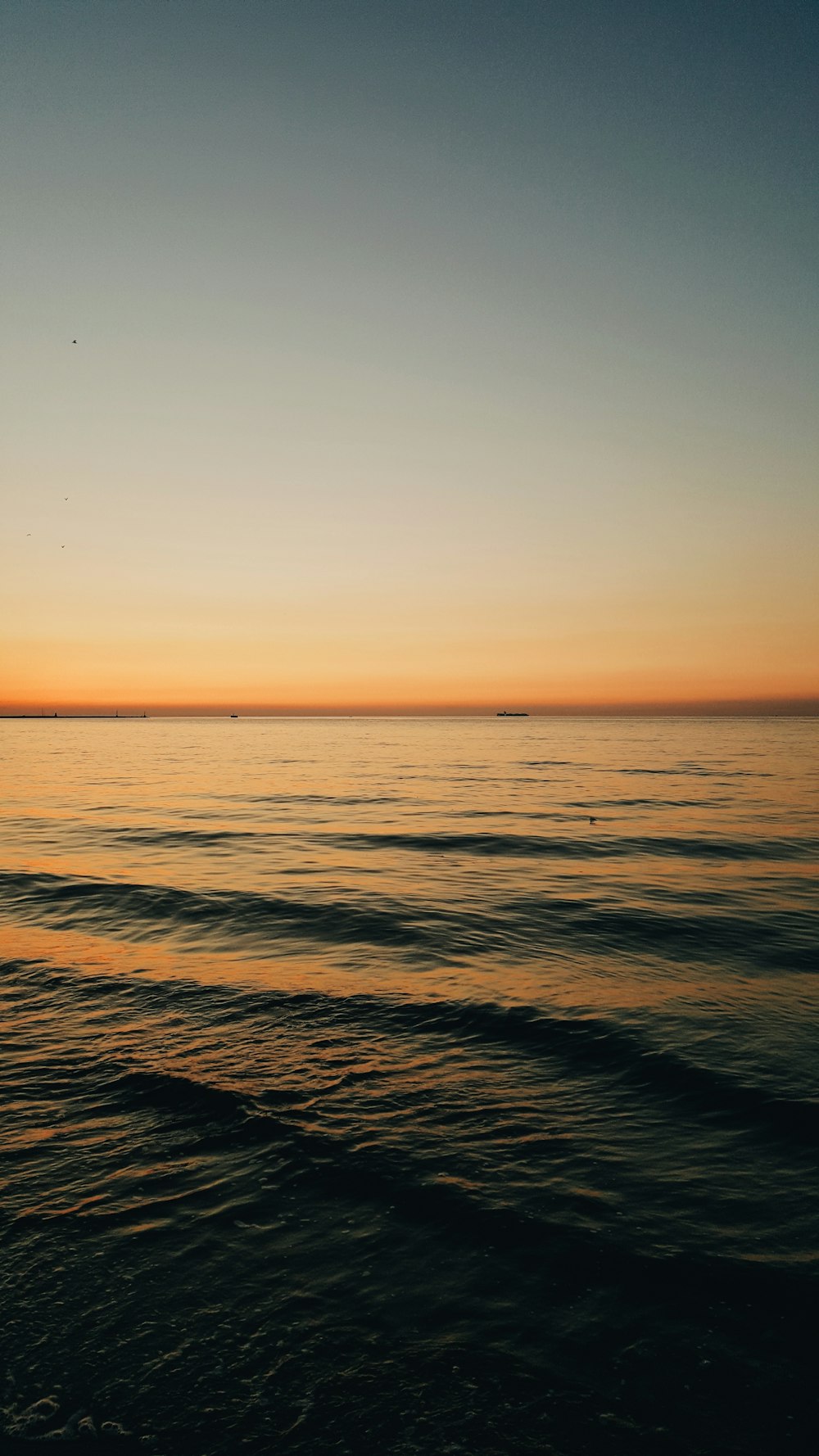 a body of water with a boat in the distance