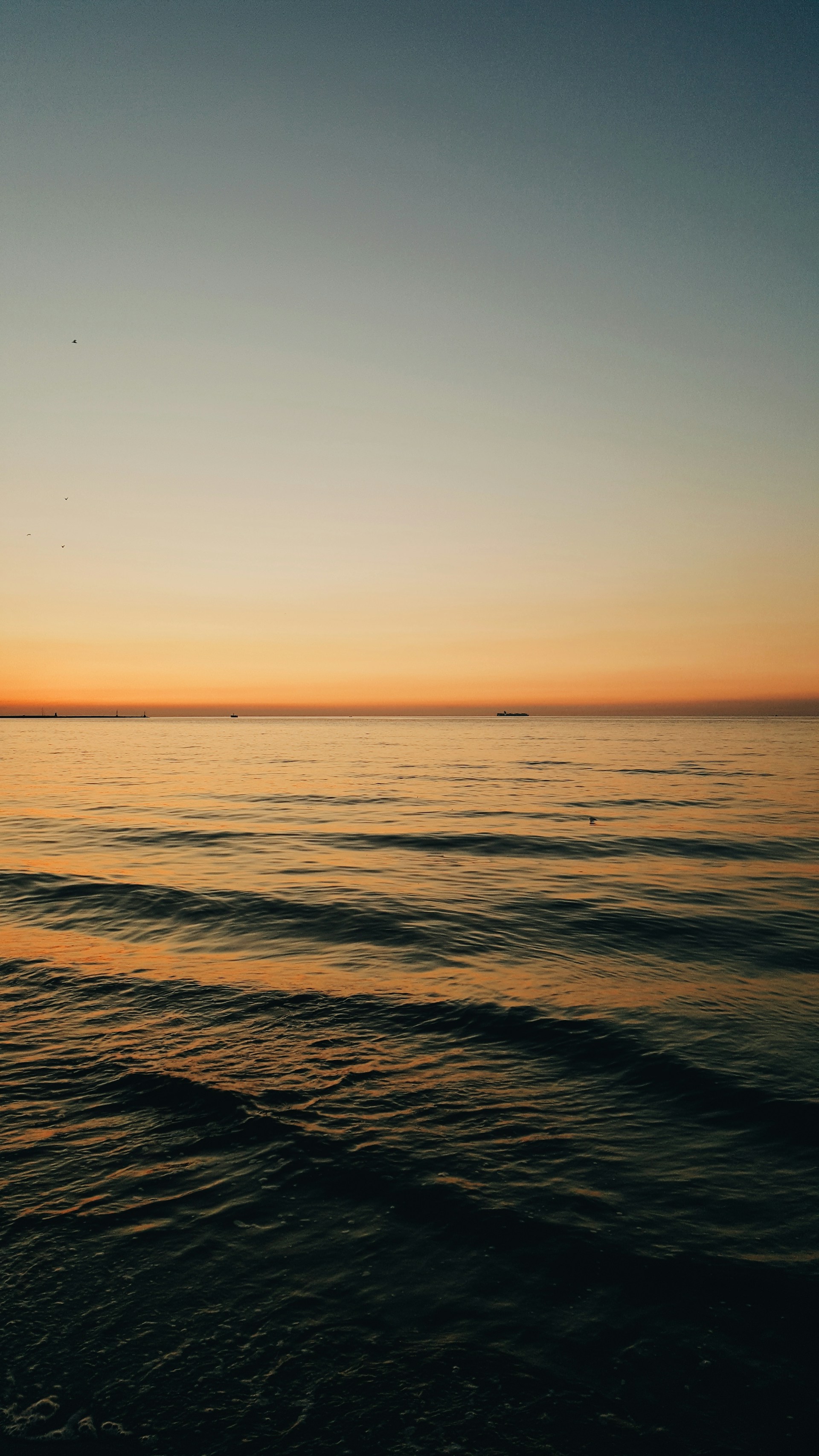 a body of water with a boat in the distance