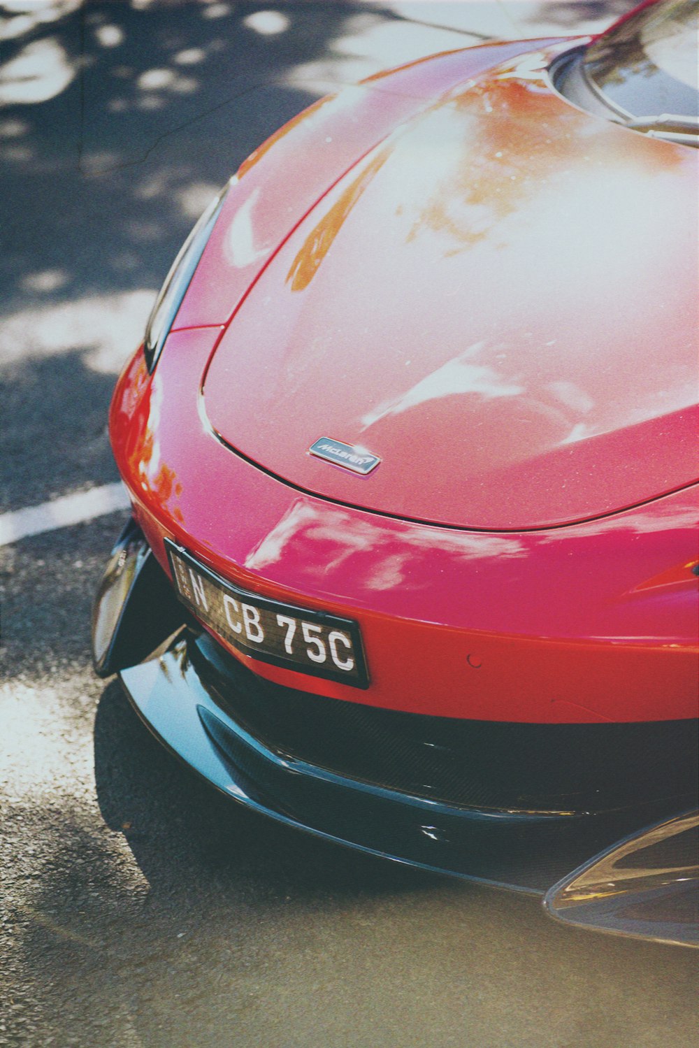 a red sports car parked on the side of the road