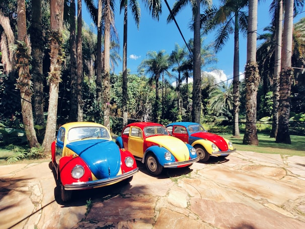 A lineup of restored retro VWs parked outside the workshop, ready for their next adventure.