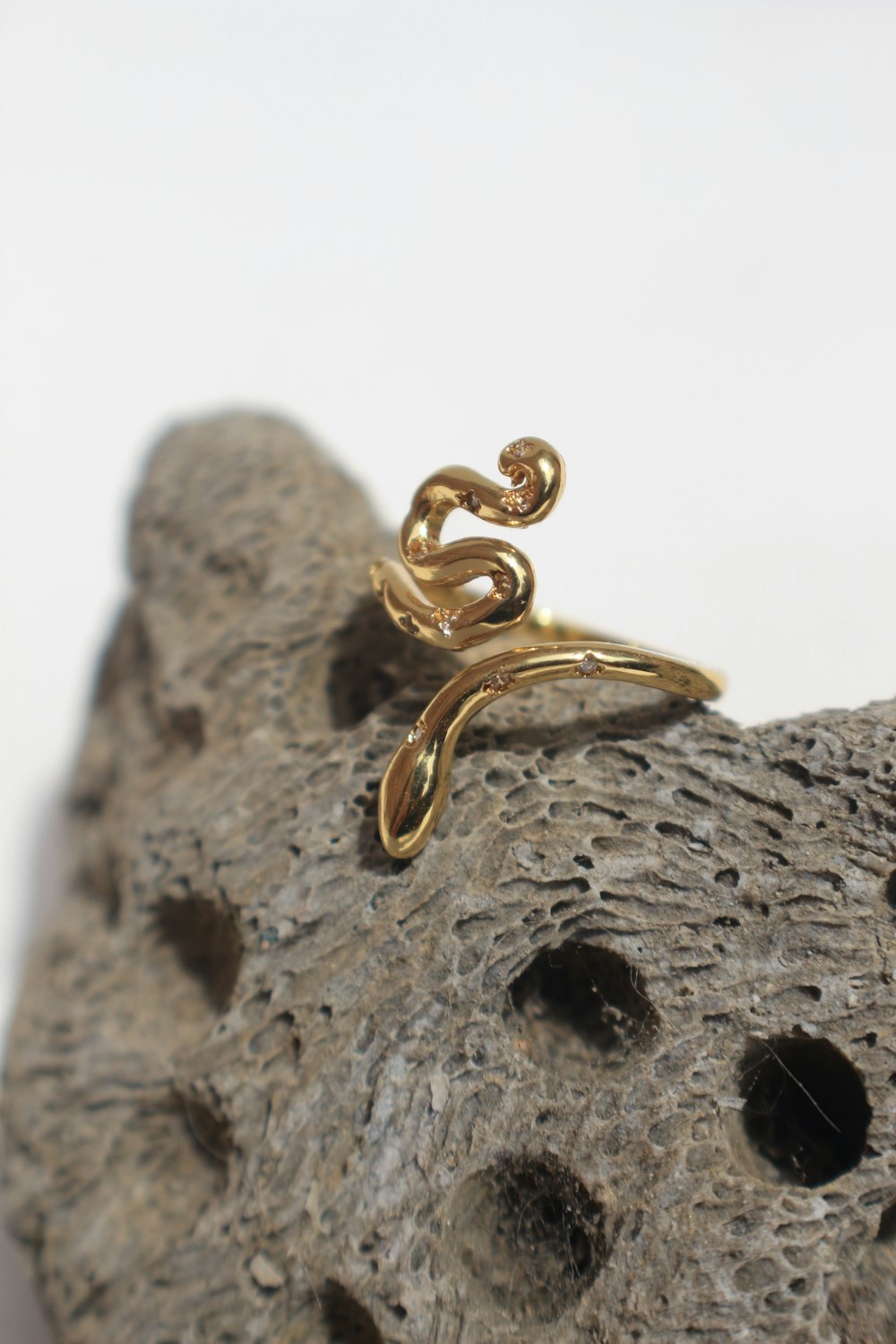 a gold ring sitting on top of a rock