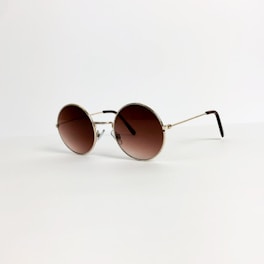A pair of round sunglasses with a gold frame and brown-tinted lenses is placed on a light, neutral background. The thin arms of the glasses extend elegantly, suggesting a lightweight design.