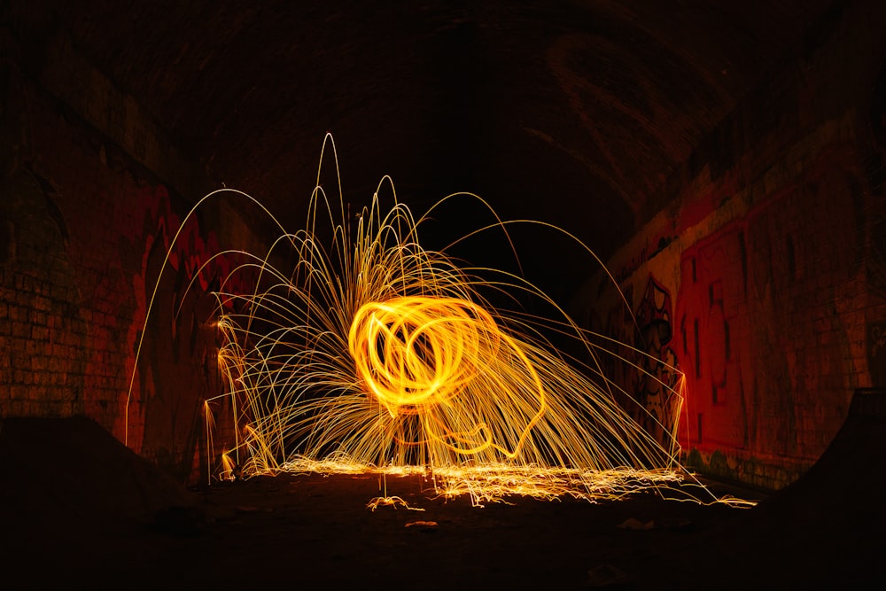 a man is spinning a fire hose in the dark