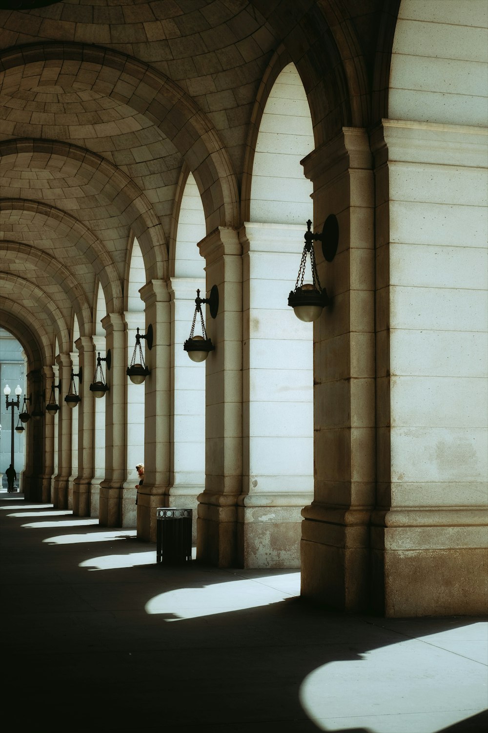 a row of pillars with a clock on each of them