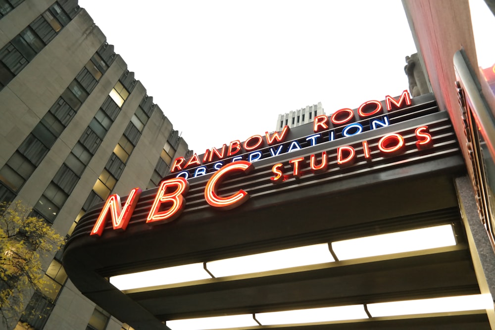 a neon sign on the roof of a building