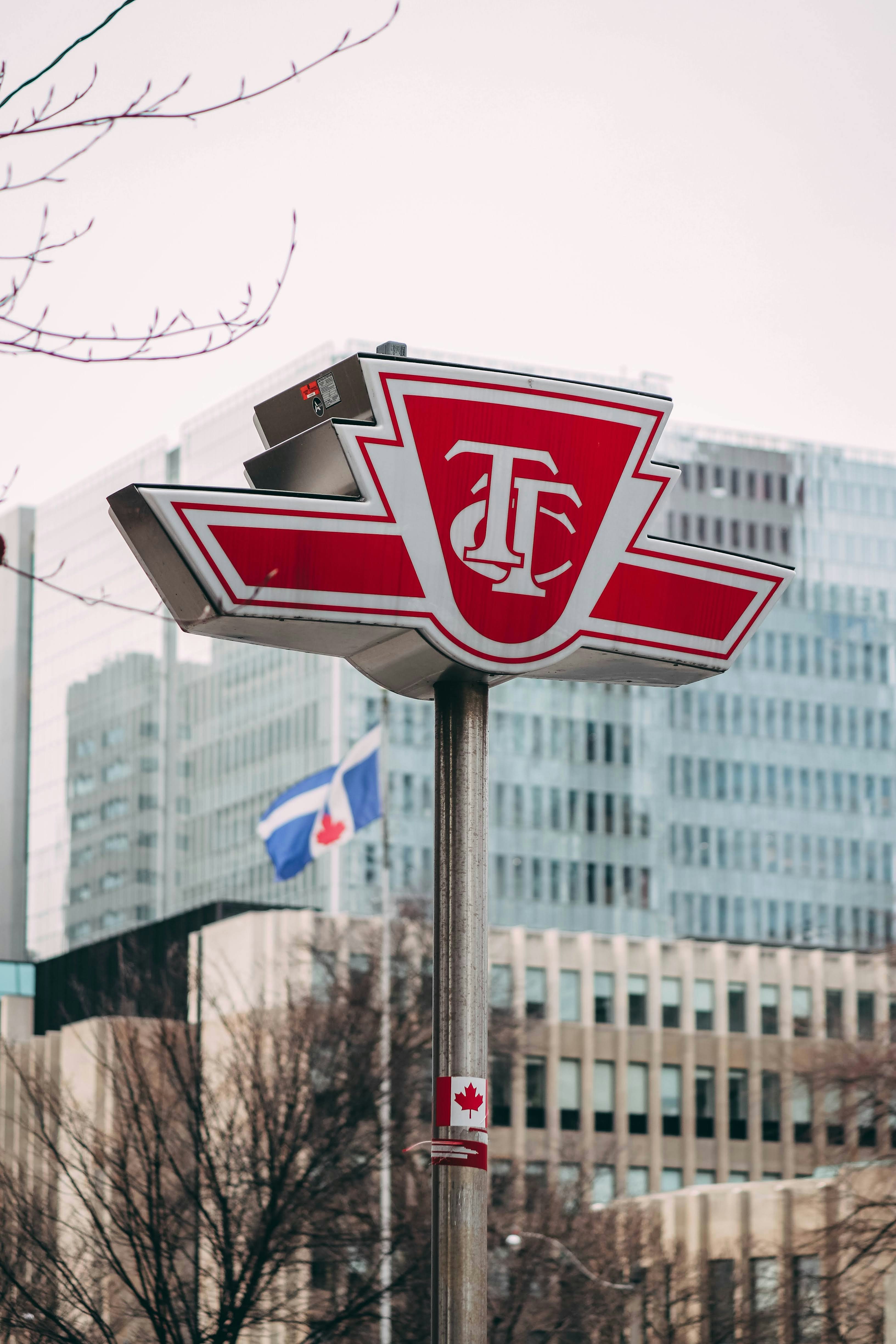 a close up of a street sign with buildings in the background