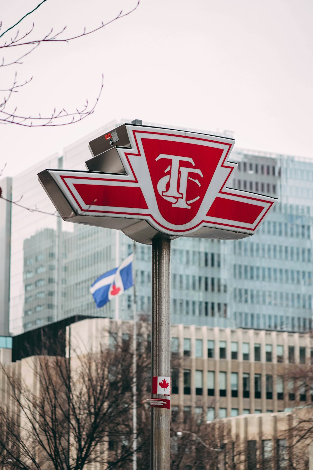 a close up of a street sign with buildings in the background