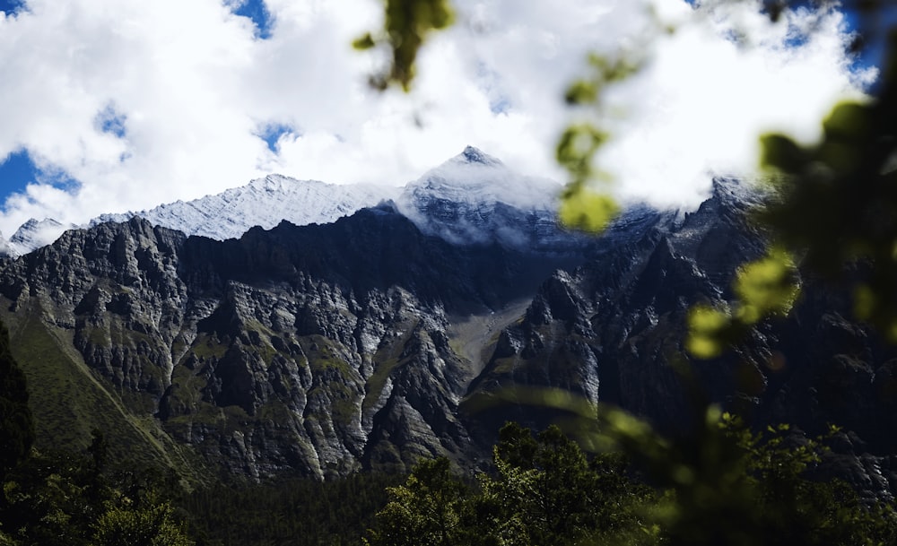 a view of a mountain with clouds in the sky