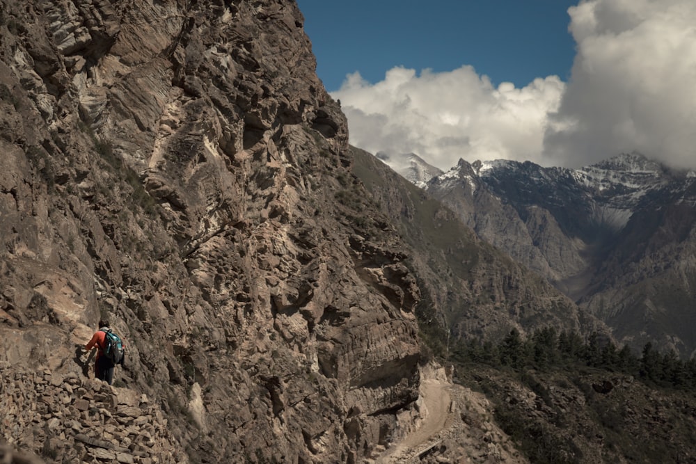 a group of people climbing up the side of a mountain