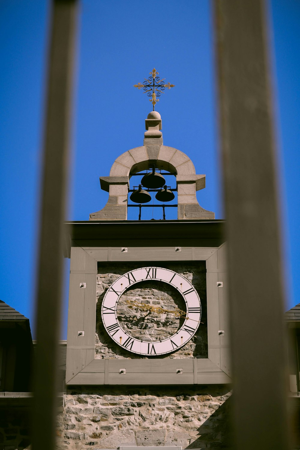 a clock tower with a bell on top of it