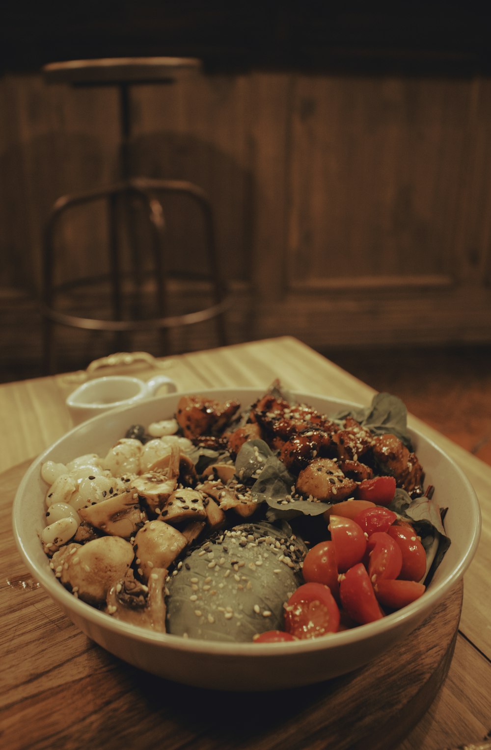 a wooden table topped with a bowl of food