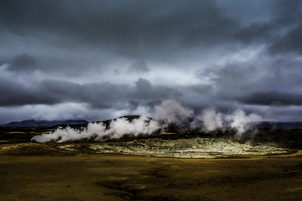 steam rises from the ground in a barren area
