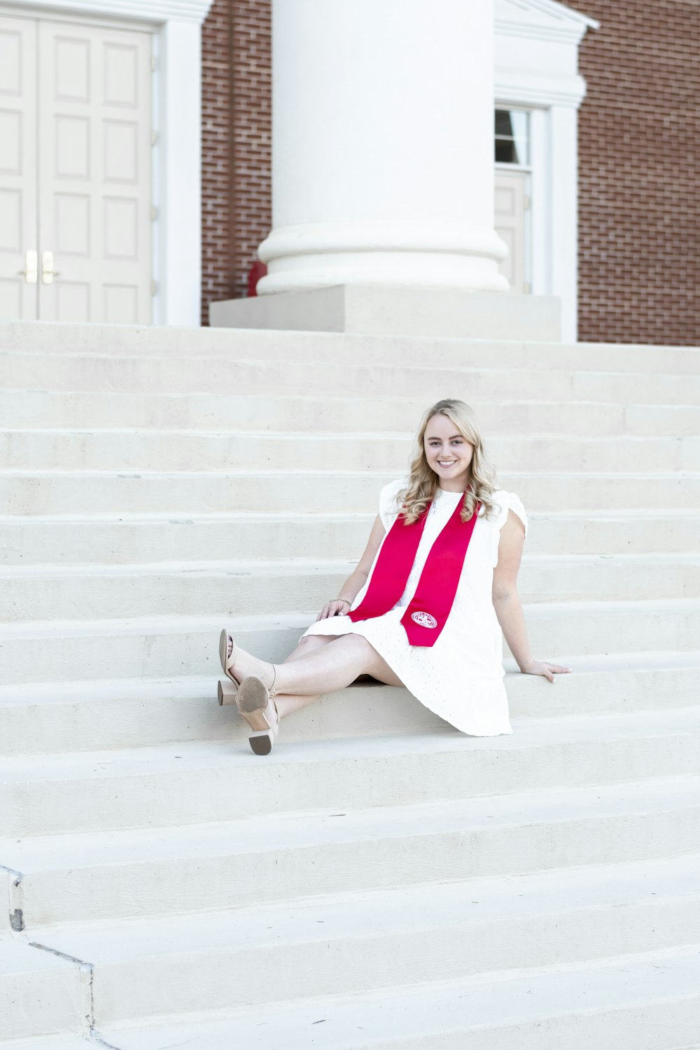 a woman sitting on the steps of a building