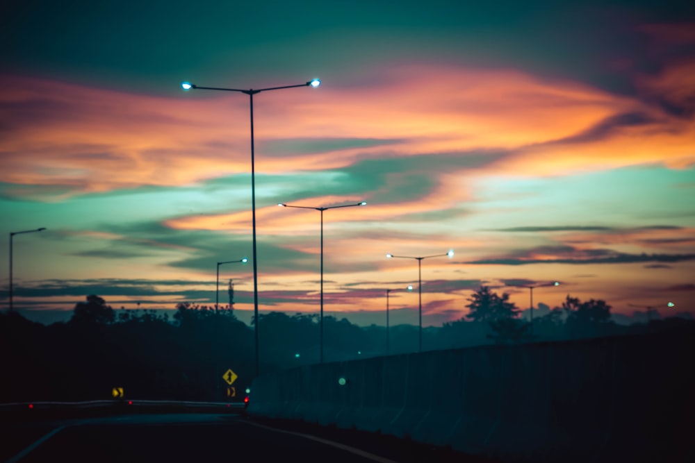 a street light sitting on the side of a road