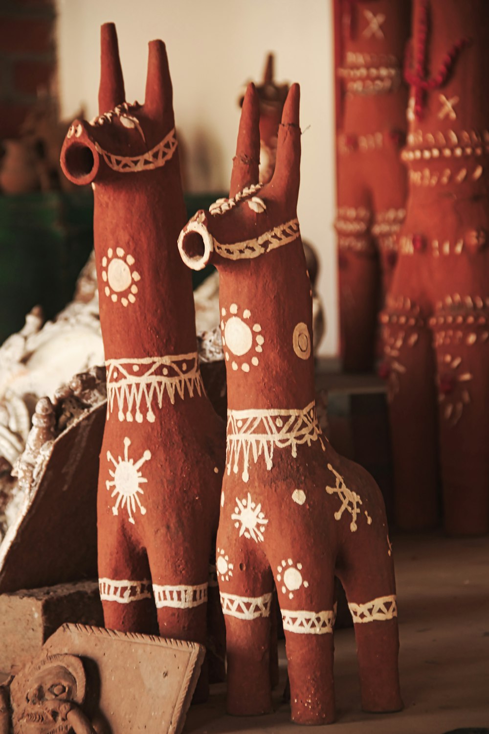 a couple of clay horses standing next to each other