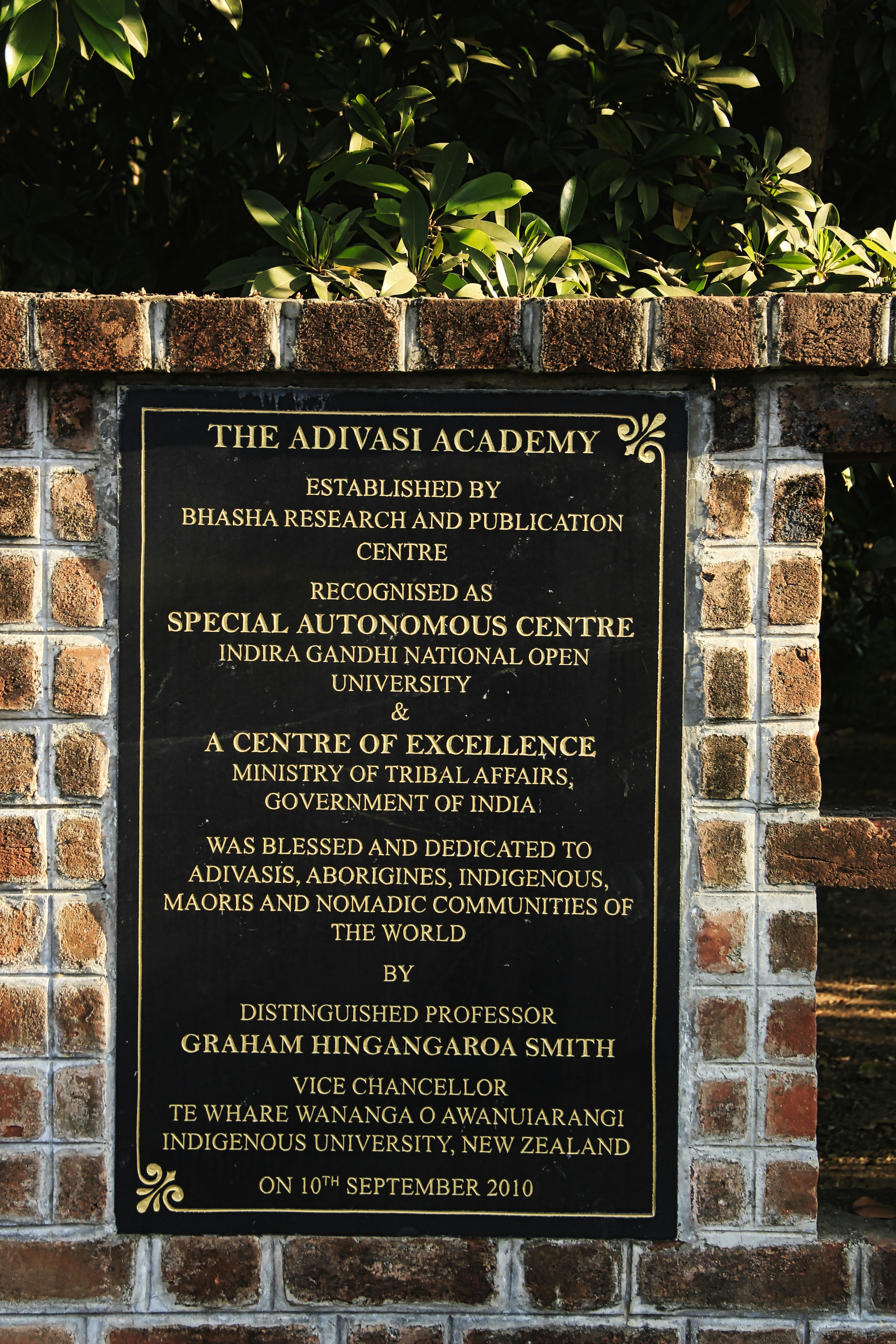 a brick wall with a plaque on it