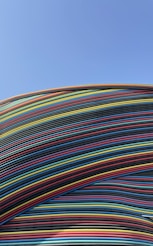 a large stack of multicolored wires against a blue sky