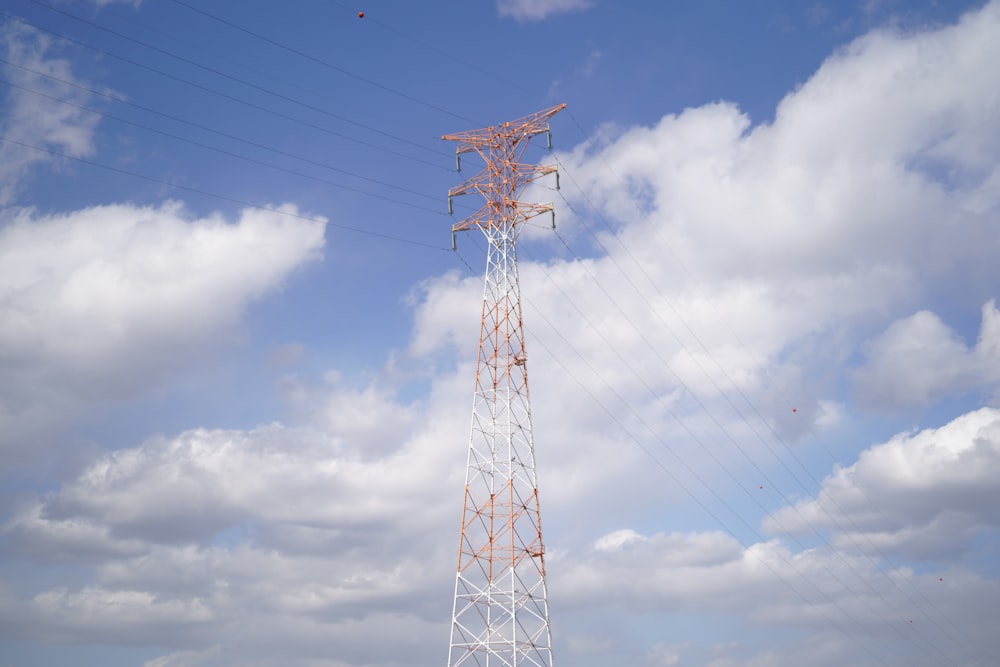 a tall white tower sitting under a cloudy blue sky