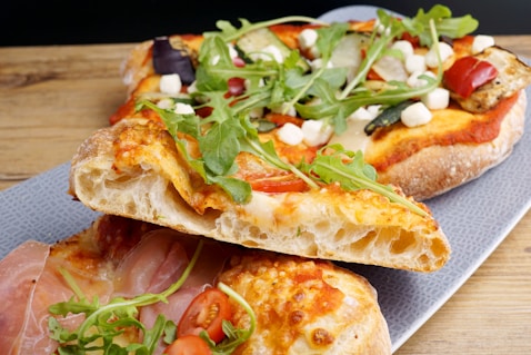 a close up of two slices of pizza on a plate