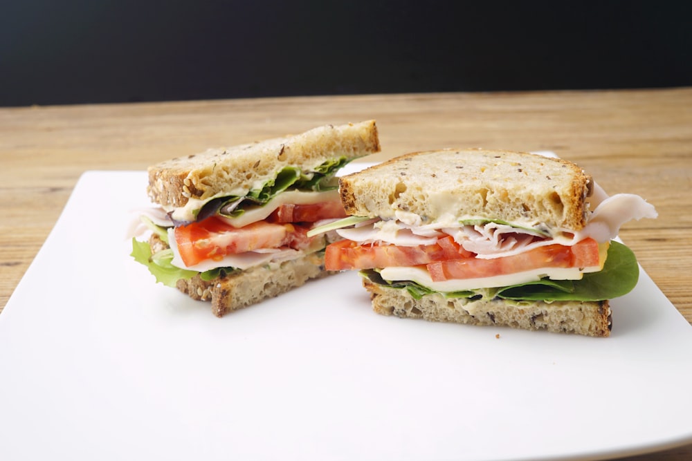 a cut in half sandwich sitting on top of a white plate