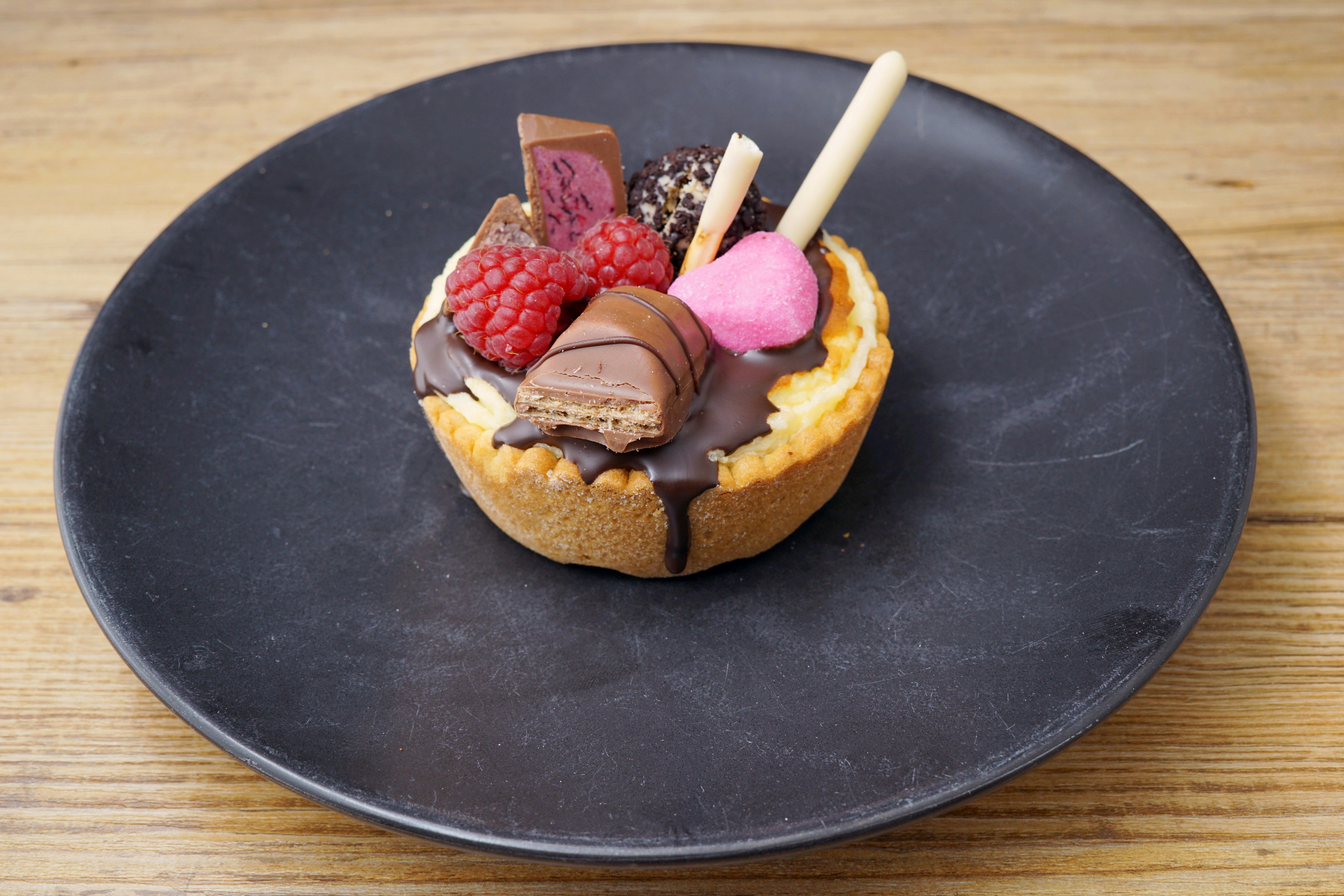 A chocolate dessert with raspberries, chocolate, and marshmallows photo ...