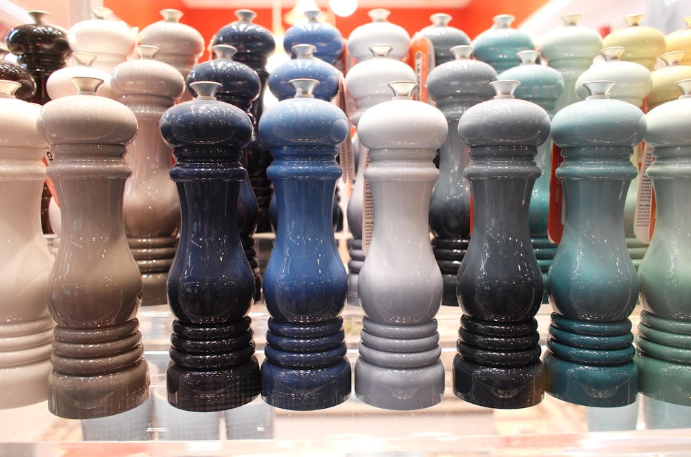 a display case filled with lots of different colored vases