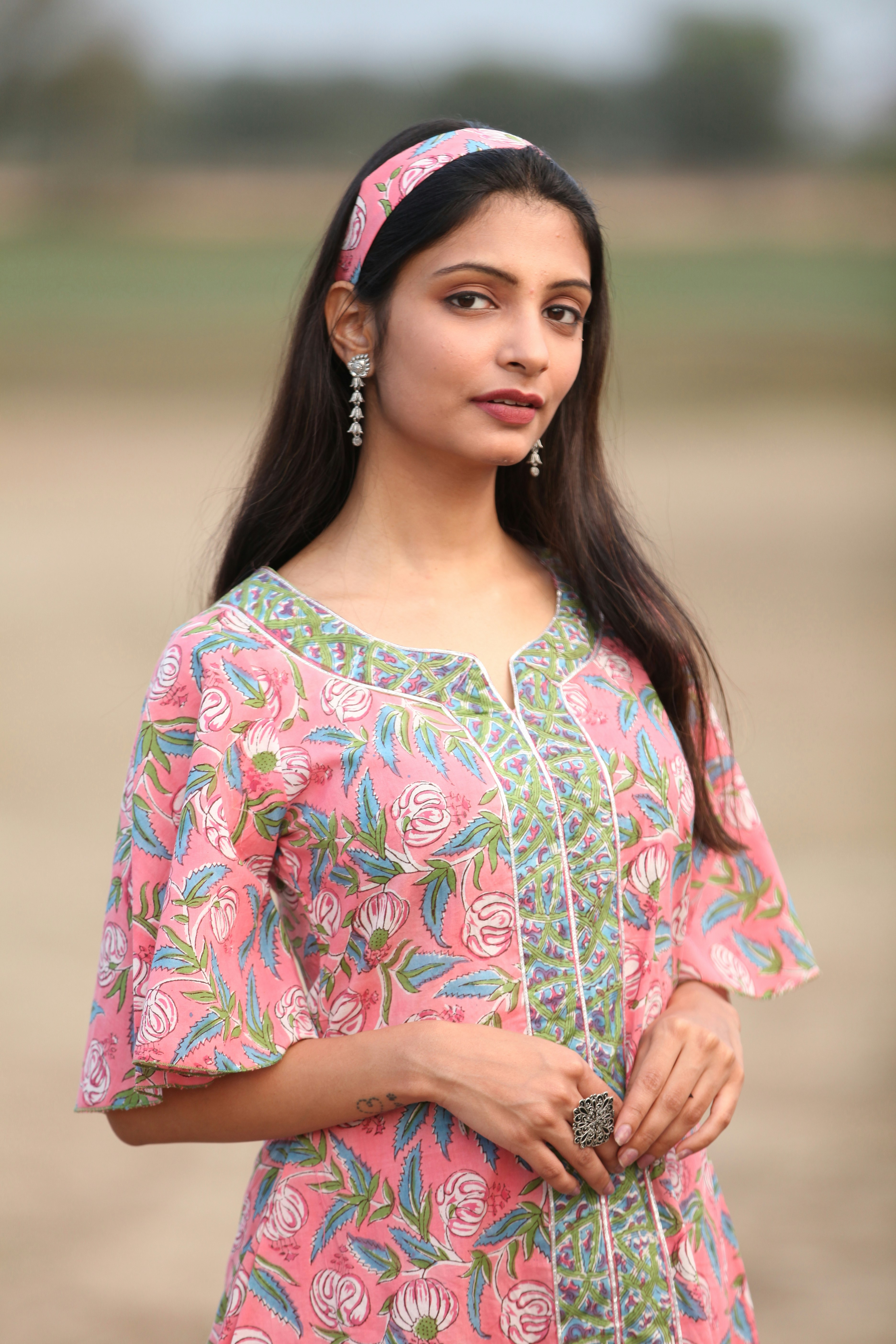 A woman in a pink and green dress photo – Free Human Image on Unsplash